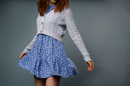 Young ginger white woman wearing dress posing on camera isolated over grey backgroundの写真素材