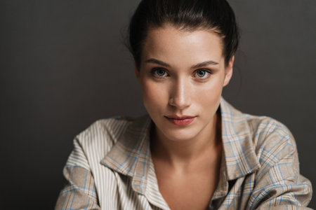 Close up of a young brunette white casual woman indoors looking at cameraの写真素材