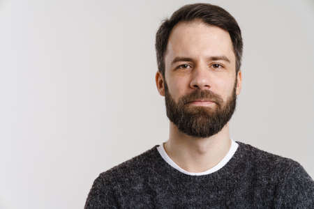 White mid man with beard posing and looking at camera isolated over white backgroundの写真素材