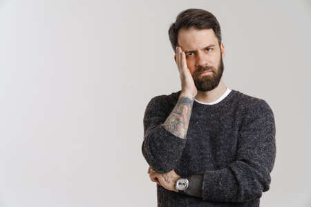 White mid man with beard covering his face and looking at camera isolated over white backgroundの写真素材