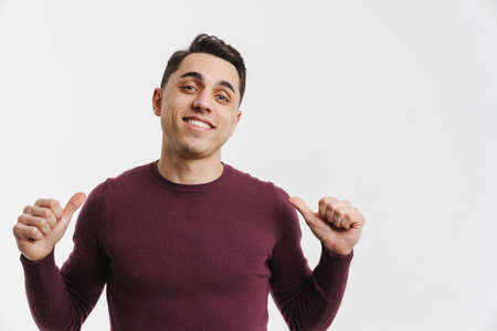 Young white man smiling while pointing fingers at himself isolated over white backgroundの写真素材