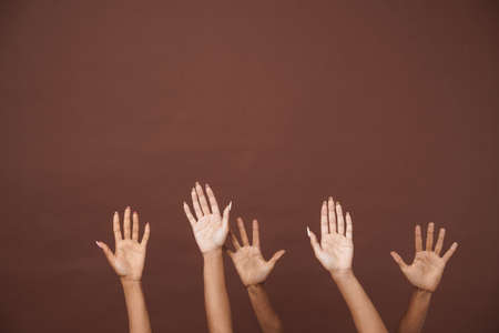 Young black three women showing her hands at camera isolated over brown backgroundの写真素材