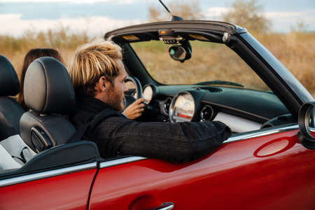 White mid couple driving together in car during tripの写真素材