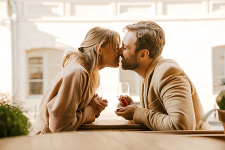 White man kissing and proposing to his girlfriend in cafe outdoors