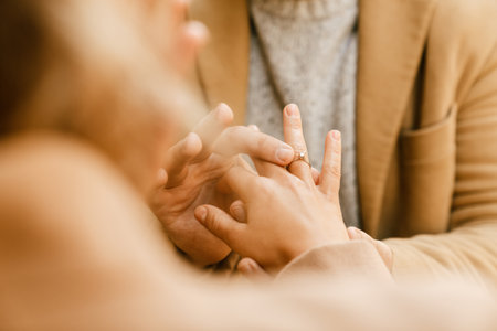 White man proposing to his excited girlfriend in cafe outdoorsの写真素材