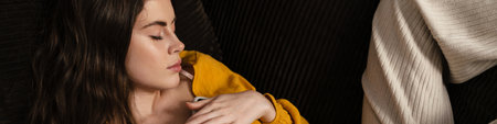 Young brunette woman sleeping on a couch with mobile phone