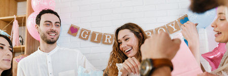 Young happy pregnant woman accepting gifts from her friends during gender reveal party indoorsの写真素材