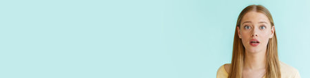 Young blonde white woman expressing surprise at camera isolated over blue background