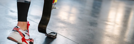 Young sportswoman with prosthesis working out indoors