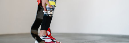 Young sportswoman with prosthesis doing exercise while working out indoorsの写真素材