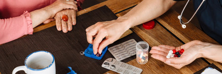A top view of a doctor separating pills for an elderly patient at home