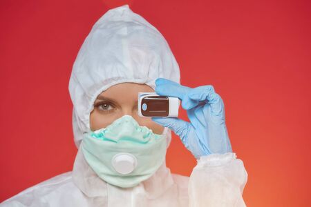 female doctor in a chemical suit. carrying out the device test for covid19 coronavirusの写真素材