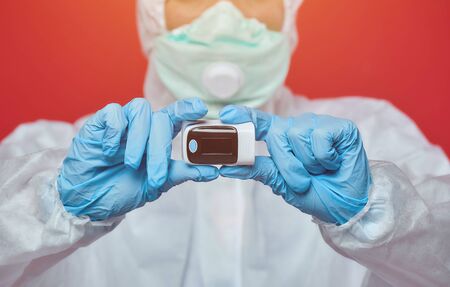 female doctor in a chemical suit. carrying out the device test for covid19 coronavirusの写真素材