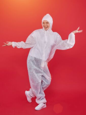 female doctor in a chemical suit. concept of medicine. red backgroundの写真素材