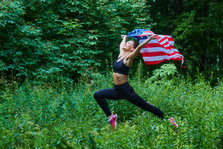 attractive girl with EU flag posing in forest park