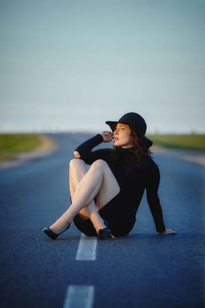 attractive girl in a striped dress posing in the summer in the fieldの写真素材