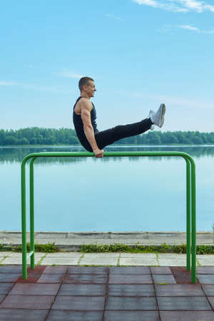 athletic man conducts morning training on the sports fieldの写真素材