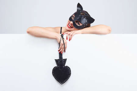 beautiful girl in a cat mask. playfully posing in front of the camera.の写真素材