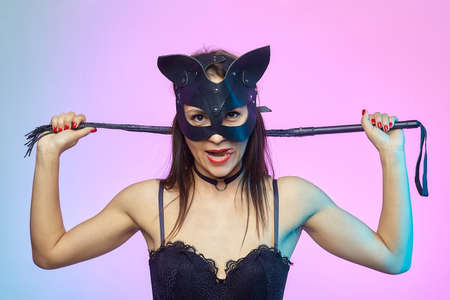 attractive girl in cat mask licking candy.の写真素材