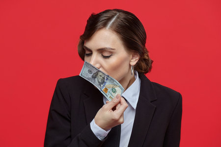 Attractive girl in retro style holding euro and dollars banknotes in different hands
