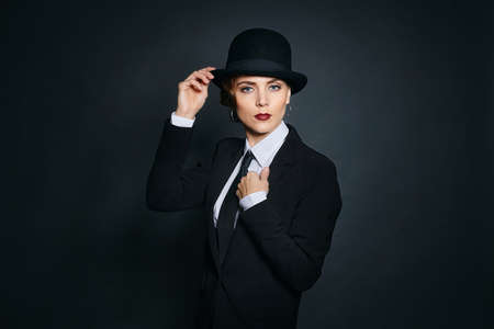 curvy young woman in a man's suit and bow tie