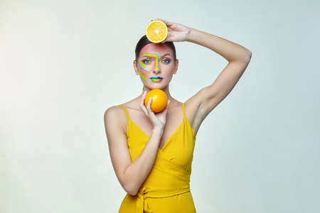 portrait of an attractive girl with bright makeup. A rainbow LGBT flag is depicted on her cheekの写真素材