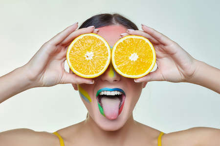 portrait of an attractive girl with bright makeup. A rainbow LGBT flag is depicted on her cheek