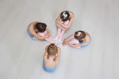 young girls sit on the floor in a choreography class.の写真素材