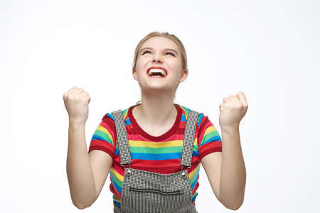 the thoughtful girl raised her index finger to her head. photo shoot on a white background.