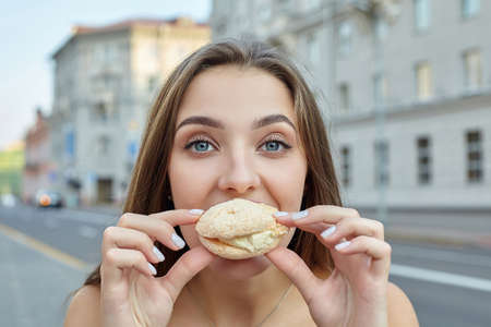 cute girl with long hair is standing in the city near a large clock ..の写真素材