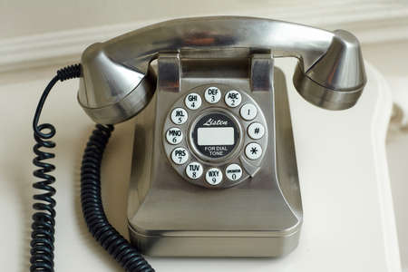old metal disc phone with the handset removed.の写真素材