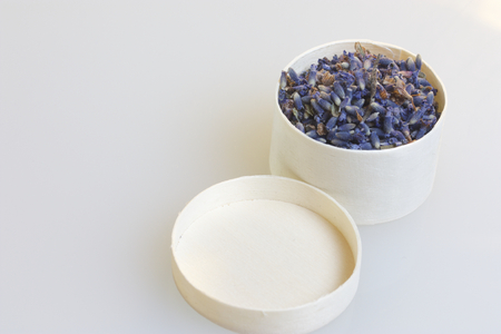 Fragrant lavender flowers, gathered in a wooden box. All on a white background, the cover of the box is close.の写真素材