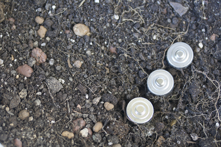 The batteries are located in the ground. Processing hazardous waste. Environmental protection.の写真素材