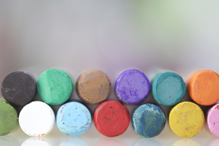 Set pastel art on a white background. Colors of rainbow. Pastel pencil arranged in two rows along...
