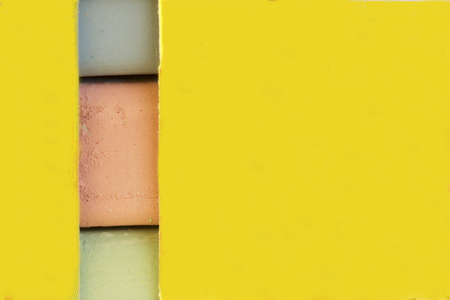 Chalk for drawing. Multi-colored chalk in paper box. Different colors can be seen through a vertical slit in the package. Green red and blue.の写真素材