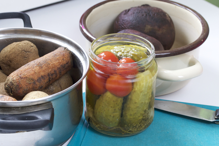 Vegetable salad vinaigrette. Russian recipes. Cooking Stages. On the table in dishes are cooked vegetables: potatoes, carrots and sugar beets. Near the bank pickled cucumbers.の写真素材
