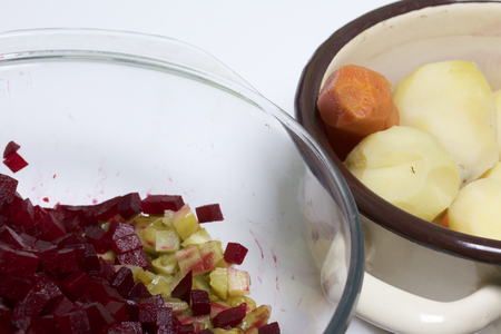 Vegetable salad. Russian recipes.  Cooking Stages. Pickled cucumbers and beetroot crumble in a single container. Peeled potatoes carrots are in another container.の写真素材
