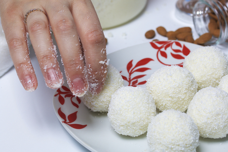 Preparation of Raffaello sweets at home. Ready-made sweets lie on a plate.の写真素材