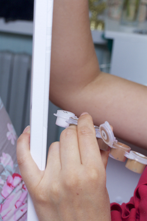 Art. Drawing by numbers. A woman paints a canvas from cotton. Uses brushes, numbered paints and water in a glass.の写真素材