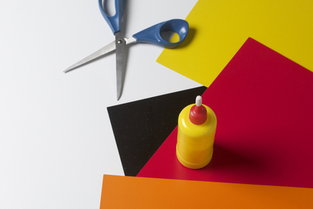 School accessories for creativity. Color paper, glue and scissors for applique. On a white background.の写真素材