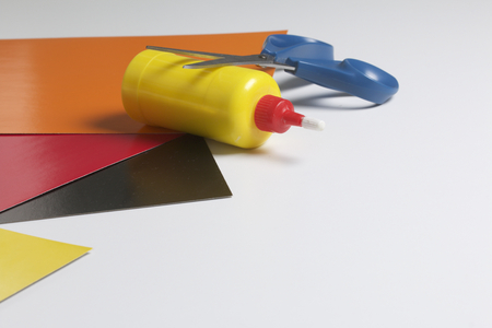 School accessories for creativity. Color paper, glue and scissors for applique. On a white background.の写真素材
