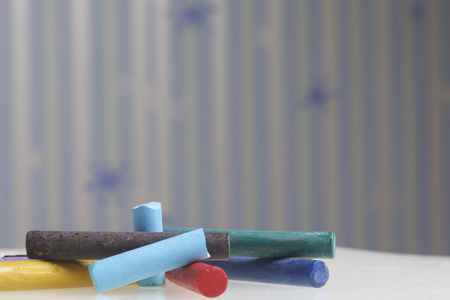 Crayons pastels in different colors. Lying in a box in their places. Diagonally across the frame.の写真素材