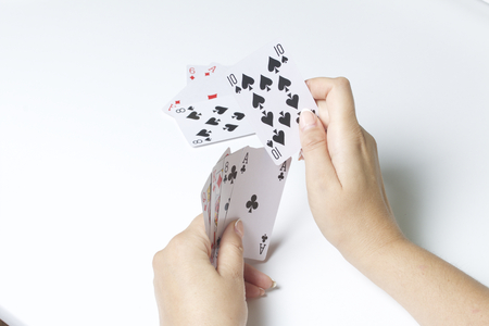 Card game. A woman makes a move - hits a smaller map of the larger. On a white background.の写真素材