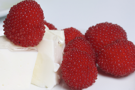Sour cream jelly, decorated with raspberries. Lies on a plate. On a white background.の写真素材