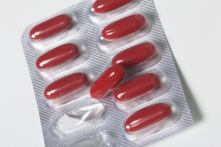 Blister with red pills. Several pills are missing.の写真素材