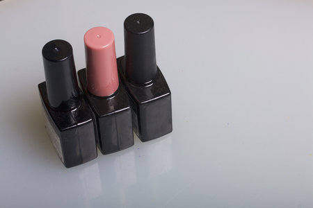Nail coating with gel-varnish. Gel-lacquer in black bottles stands on a white surface.の写真素材