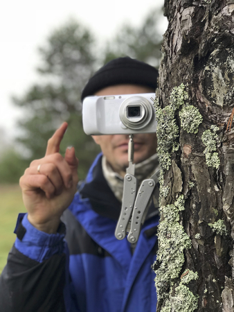 Photographing using improvised means. A compact camera is mounted on a folding knife, stuck stuck in...