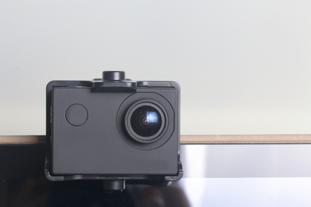 The action camera is fixed on the tablet. On a white background.の写真素材