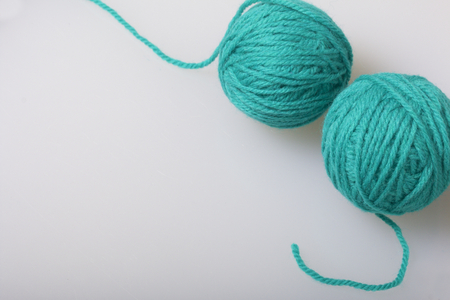 Tangle of thread for knitting emerald color on a white background.の写真素材