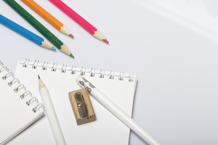 Stationery for school and teaching. Notepad and pencils for writing and drawing. Sharpener for pencils.の写真素材